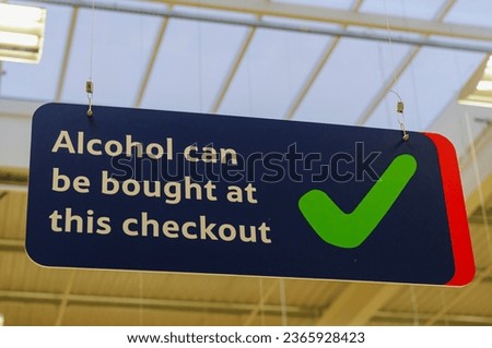 Sign advising customers that alcohol can be purchased at this checkout (Northern Ireland Licencing laws)