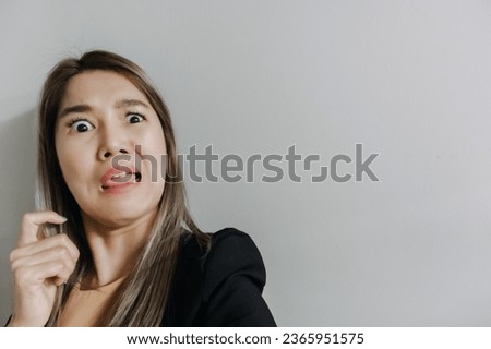 Asian office woman funny shocked bored face on white wall.