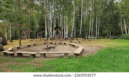 a place for a campfire in a forest camp, gazebos against the background of birch trees, the beginning of autumn, photo