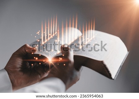 Old holy Bible on black background, Prayer with a Holy Bible in church concept for faith, spirituality and religion, woman praying on holy bible in the morning. woman hand with Bible praying.