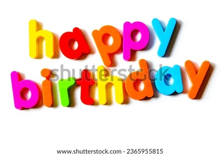 Fridge magnets magnetic letters spelling out "happy birthday"
