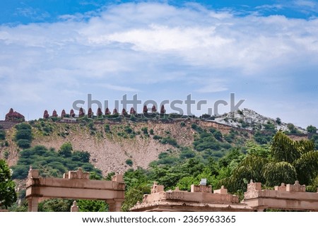 artistic series or red stone jain temple at mountain top with bright blue sky at morning image is taken at Shri Digamber Jain Gyanoday Tirth Kshetra, Nareli, Ajmer, Rajasthan, India.
