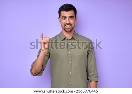 cheerful brunette bearded man demonstrating the letter I i. sign language symbol for deaf human in blue background. isolated
