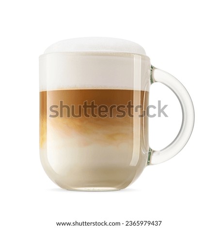 Frothy coffee cappuccino with whipped milk cap in transparent glass mug isolated on white background.