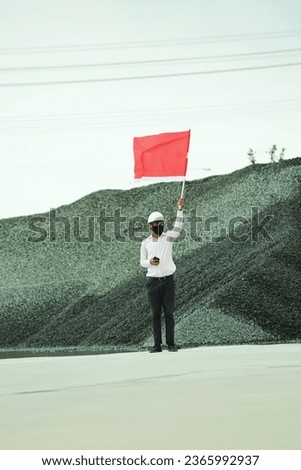 Construction worker waving a red flag and making a stop hand gesture isolated on white background 