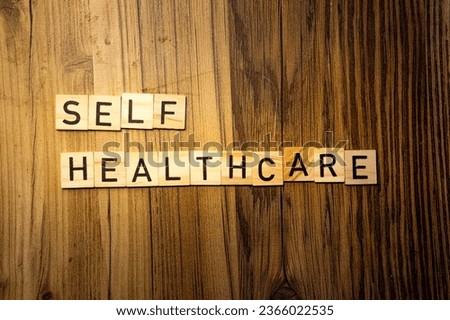 Self Healthcare concept word in wooden letters on dark wood background