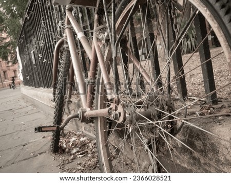 old bike at metal fence