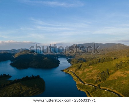 drone shot aerial view top angle photograph hill mountain lake view outdoor tea plantations megamalai forest tourism sunshine wallpaper background turquoise blue water reservoir munnar ooty india
