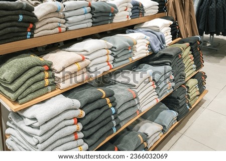 Black Friday. A woman in a store picking out clothes, the season of discounts and sales. A day of mega discounts, sale,Black Friday Shopping Week Royalty-Free Stock Photo #2366032069