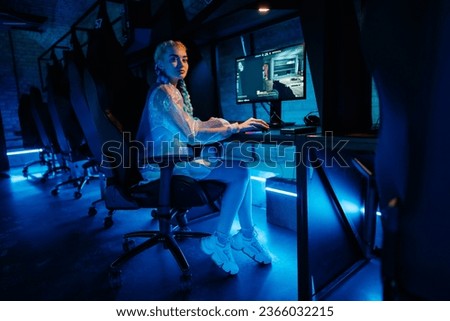 Young female cyber gamer, cosplayer plays computer games. High quality photo