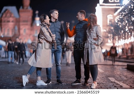 red square evening winter, a group of friends for a walk new year christmas moscow russia
