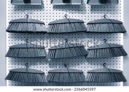 Plastic brushes for cleaning an apartment and office in a rack in a store, cleaning concept background