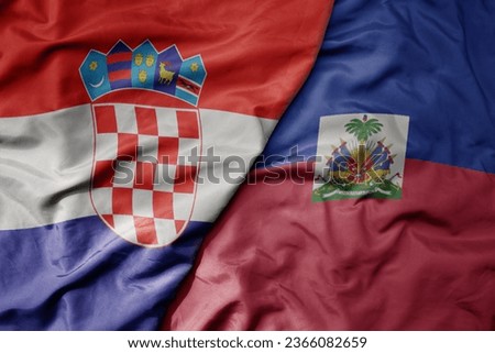 big waving national colorful flag of croatia and national flag of haiti . macro