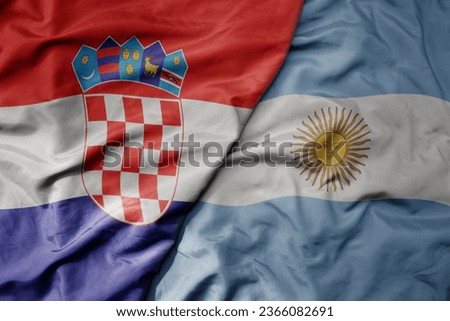 big waving national colorful flag of croatia and national flag of argentina . macro