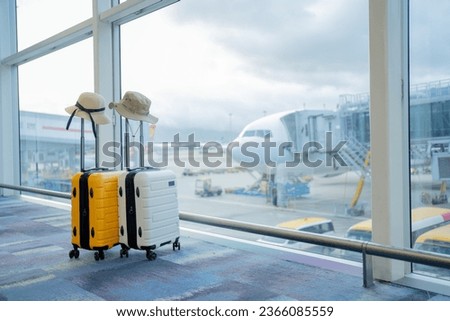 Two suitcases in an empty airport hall, traveler cases in the departure airport terminal waiting for the area, vacation concept, blank space for text message or design Royalty-Free Stock Photo #2366085559