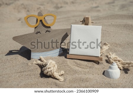 Empty whiteboard frame with copy space for your text or design displays on sandy beach. Starfish in glasses decoration. Summer vacation and holiday business travel concept. Template Mock up for sale