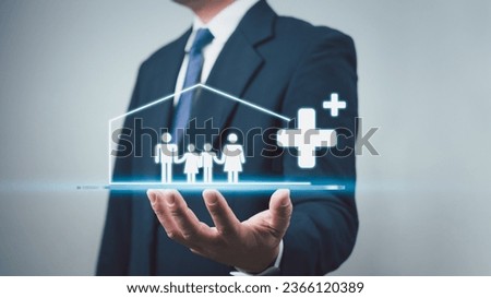 Concept of health insurance and medical benefits. Businessman showing family icons in house frame and plus sign. Health insurance and access to health care. Health care planning.