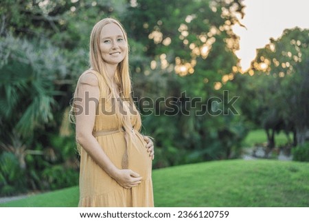 happy pregnant woman walking in the park