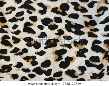 Leopard texture fabric, background,Brown black and white leopard pattern. Fur animal print as background.