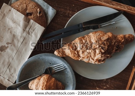 Woman is having croissant and iced lemon tea in the cafe. High quality photo