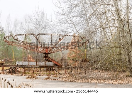 Carousel in abandoned amusement park in ghost town Pripyat, Ukraine. Chornobyl exclusion zone Royalty-Free Stock Photo #2366144445