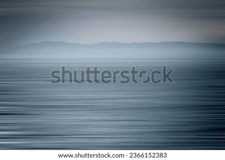 Artistic motion blur of the ocean in a blue tone with an island in the background. The  island is Catalina Island California  Royalty-Free Stock Photo #2366152383