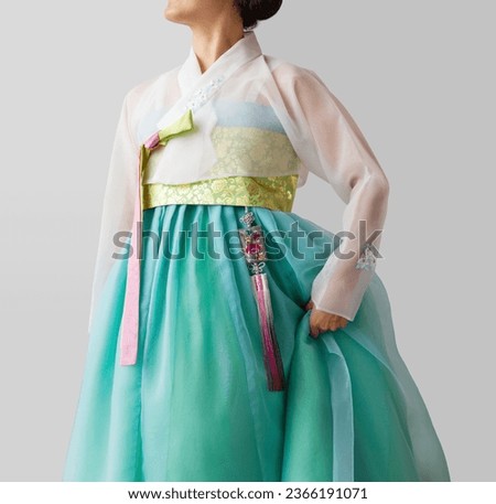 The woman wearing colorful Hanbok, Korean traditional dress. Isolated on white background. Holiday greeting concept. 
 Royalty-Free Stock Photo #2366191071