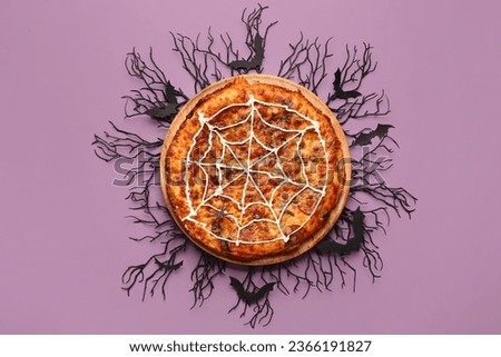 Wooden board with tasty pizza and decorations for Halloween party on purple background