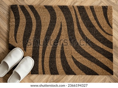 White slipper on a leopard print  doormat