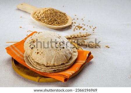 pakistan and indian bread with wheat grains in background Royalty-Free Stock Photo #2366196969