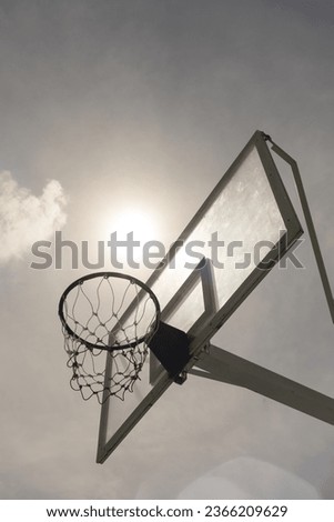 Outdoor basketball hoop against the blue sky.Low angle view.
