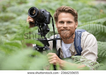 landscape photographer with tripod in the countryside