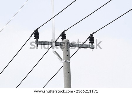 Explore the world of electricity in this photograph of a power line tower. The image showcases the towering structure with wires extending into the distance.