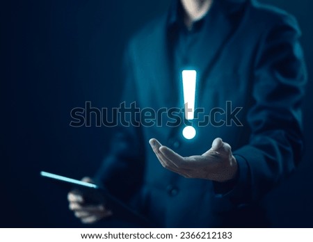 businessman's hand shows an icon exclamation mark. points attention. concept of signal alert, caution, or idea. information important in business and security Royalty-Free Stock Photo #2366212183