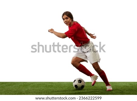 Young sportive girl, female football player in motion, training, dribbling ball isolated over white background. Concept of professional sport, competition, game, training, youth, action, ad