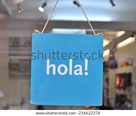 ¡Hola! - A Spanish Greeting: Vibrant Blue Message Board on Display in a Glass Door