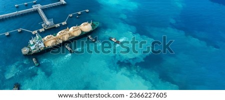 LNG (Liquefied natural gas) tanker anchored in Gas terminal gas tanks for storage. Oil Crude Gas Tanker Ship. LPG at Tanker Bay Petroleum Chemical or Methane freighter export import transportation  Royalty-Free Stock Photo #2366227605