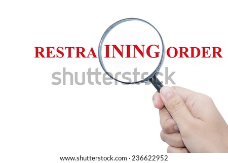 Hand Showing RESTRAINING ORDER Word Through Magnifying Glass  Royalty-Free Stock Photo #236622952