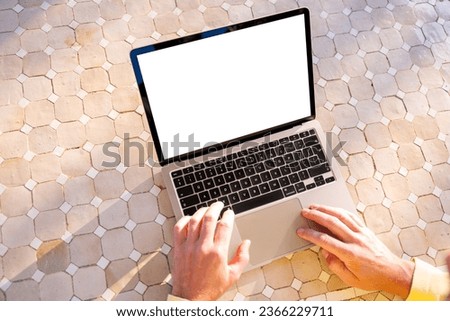 Person using laptop, blank white screen mockup