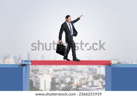 Attractive young european businessman crossing pencil bridge on sky background. Career problem and gap concept