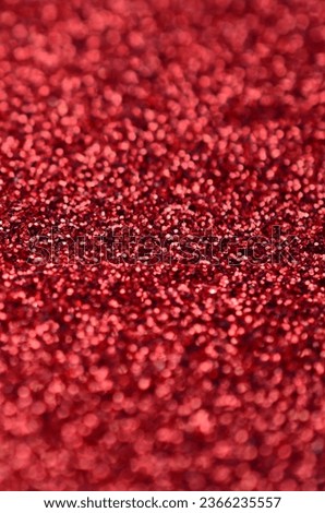 Crimson red decorative sequins. Background image with shiny bokeh lights from small elements that reflect light