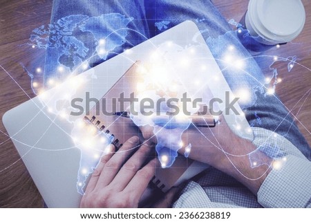 Double exposure of hands and notepad with business icons. Concept of international business.