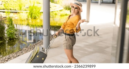 attractive woman with suitcase going on holidays