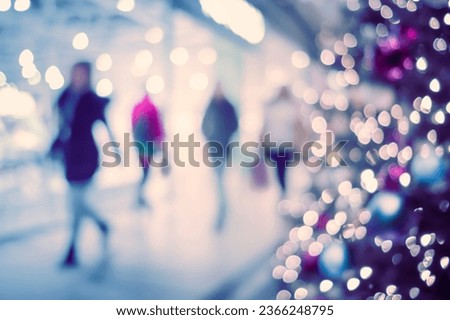 ChristmasShopping. Christmas lights with  silhouettes of defocused shoppers in a shopping mall.
