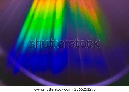 Abstract light beams filtering from surface into deep blue in rainbow burst