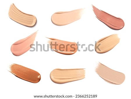 Foundation of different textures and shades for various skin types isolated on white. Set with samples of makeup product Royalty-Free Stock Photo #2366252189