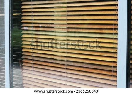 Large shop window with blinds and urban background reflection mockup template. Empty office window for business logo mock up template.