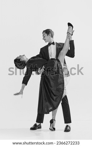 Elegance and passion. Black and white. Attractive young woman and handsome man dancing lindy hop. Concept of hobby, retro dance, vintage style, choreography, beauty. Monochrome art. Ad Royalty-Free Stock Photo #2366272233
