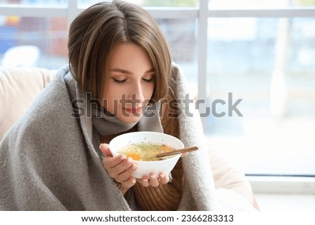 Ill young woman eating chicken soup at home, closeup Royalty-Free Stock Photo #2366283313