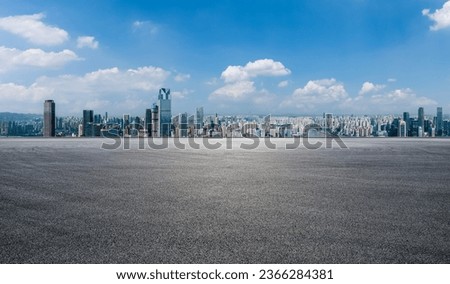 Asphalt road square and city skyline with modern buildings